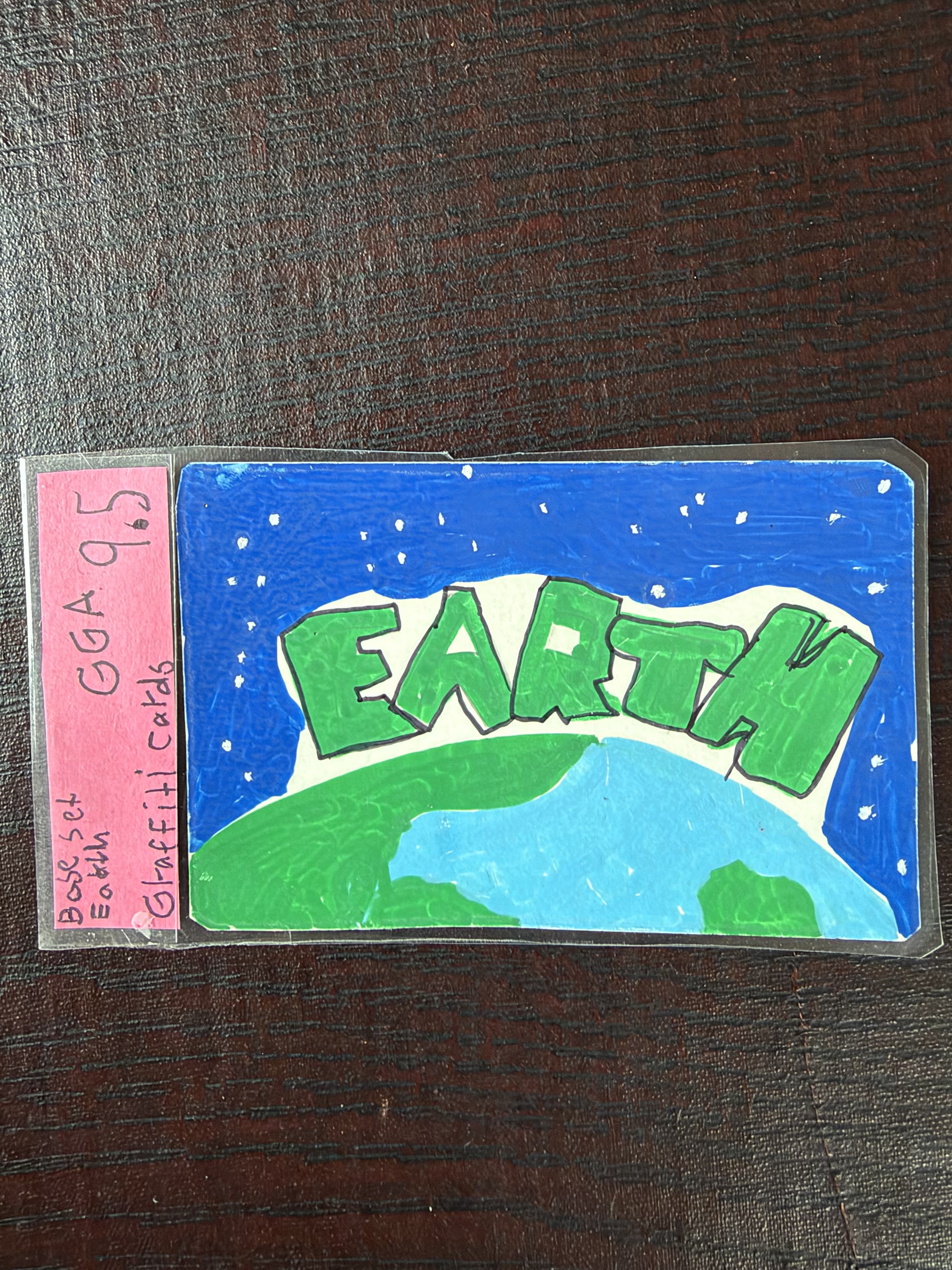 Graded Earth graffiti card in green and blue marker