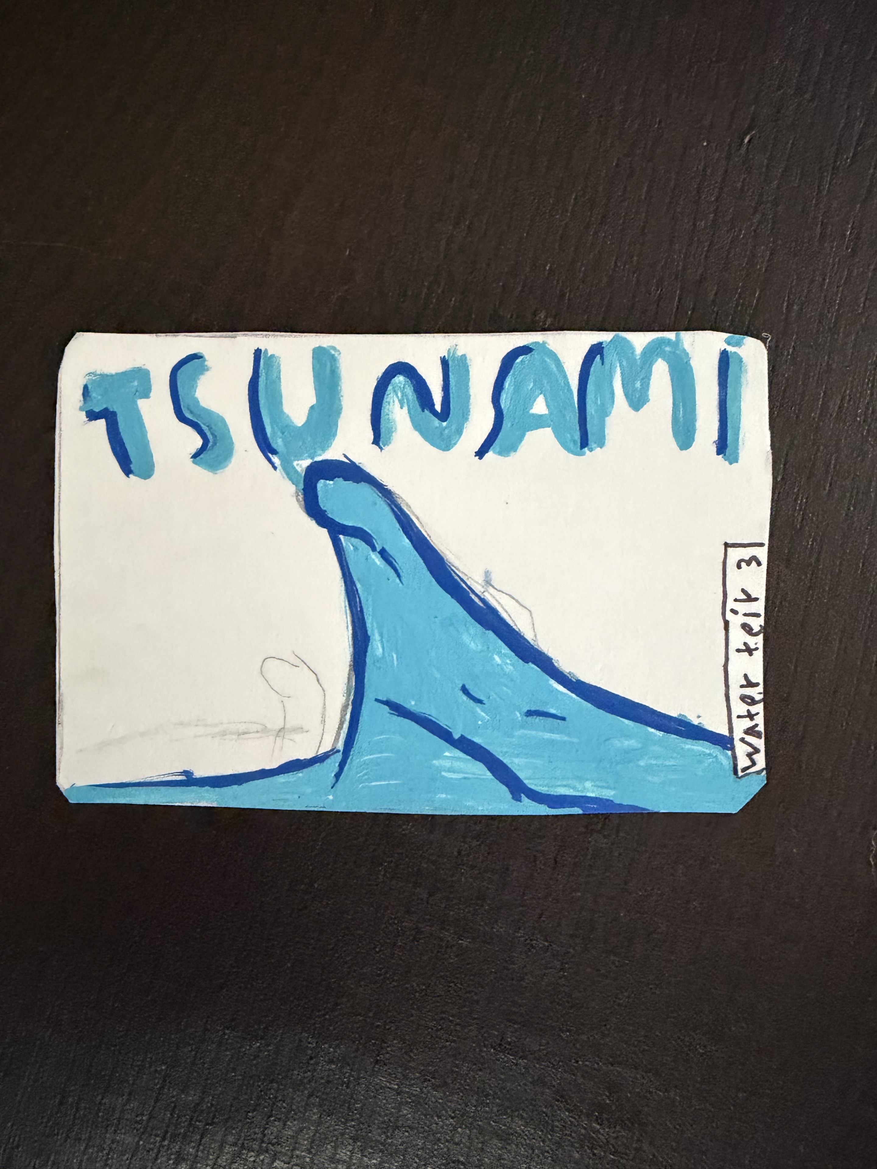 Production Tsunami graffiti card in blue marker